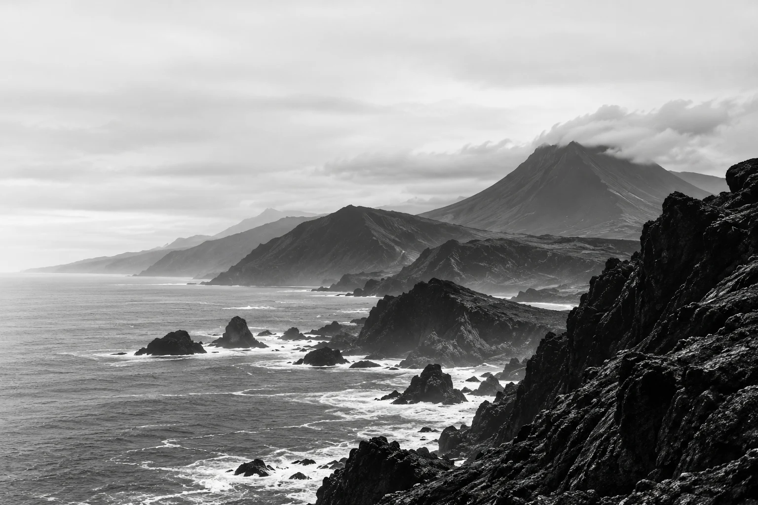 Volcanic coastline of the Azores under a soft grey sky