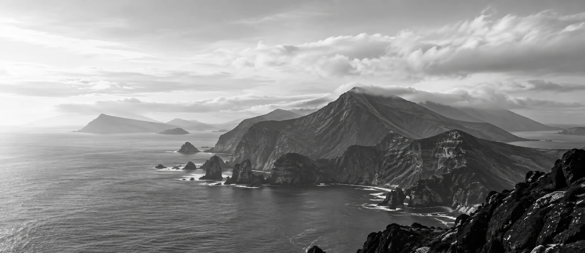 Sea cliffs and headlands of the Azores fading into a bright haze