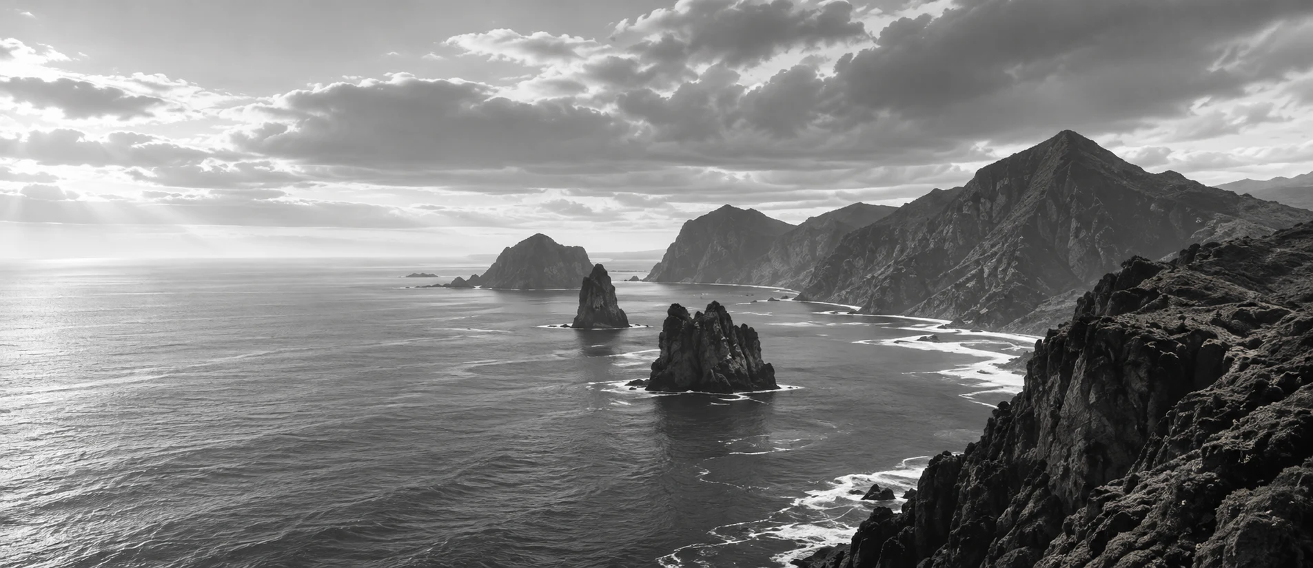 Sea stacks and a rugged coastline under a luminous sky