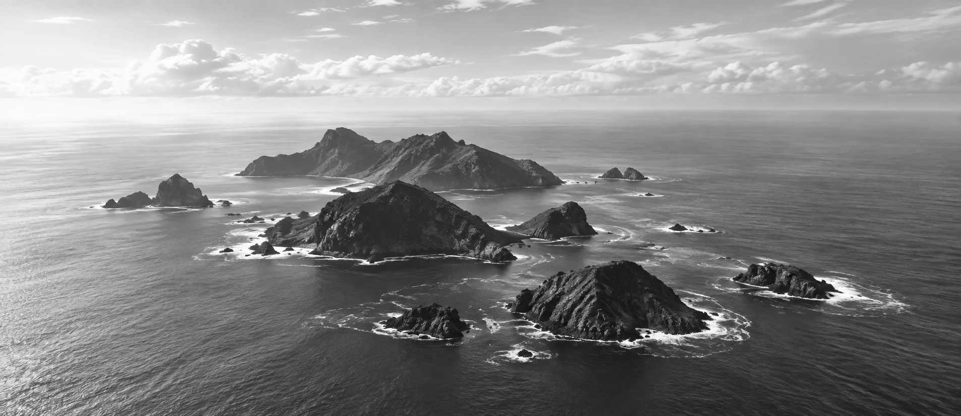 A cluster of small volcanic islands in a calm grey Atlantic
