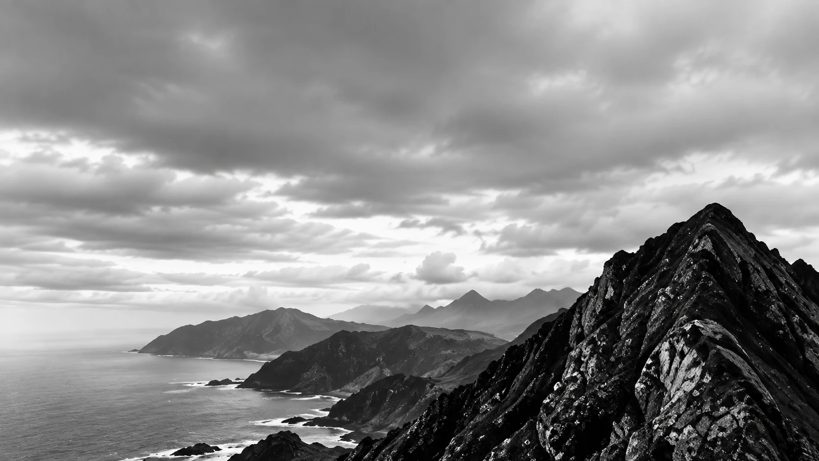 A mountain ridge overlooking a curving coastline