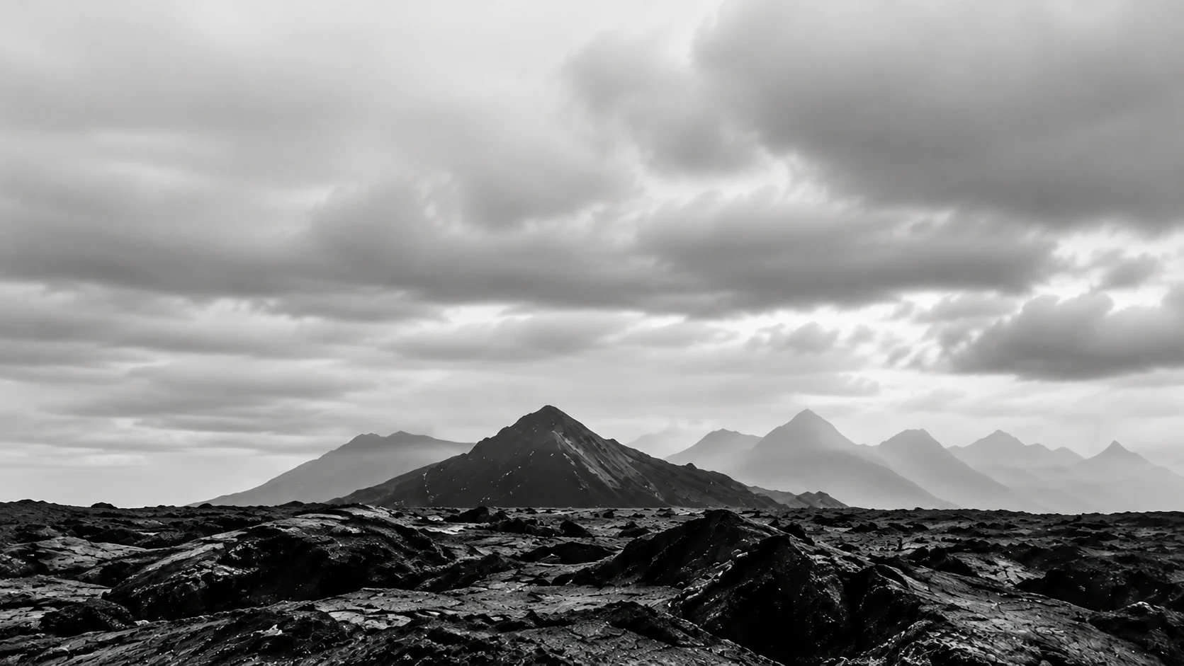 A wide volcanic plain leading to distant mountains